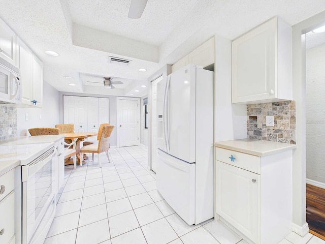 kitchen with light countertops, a ceiling fan, white cabinetry, light tile patterned flooring, and white appliances