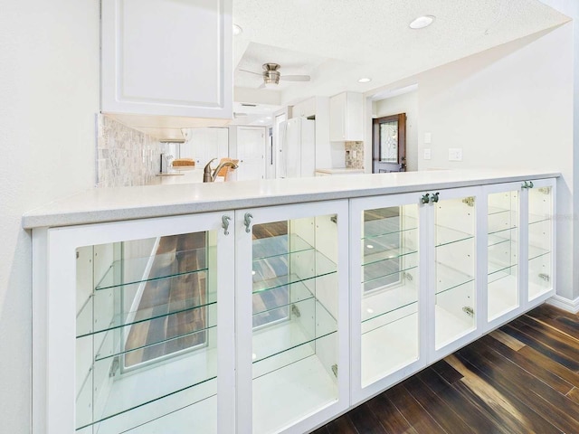 bar featuring a textured ceiling, recessed lighting, dark wood-type flooring, freestanding refrigerator, and tasteful backsplash