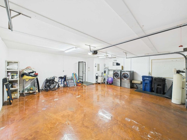 garage with a garage door opener and separate washer and dryer