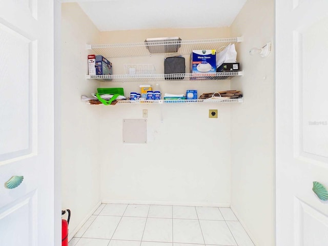 laundry room with laundry area, electric dryer hookup, and tile patterned floors