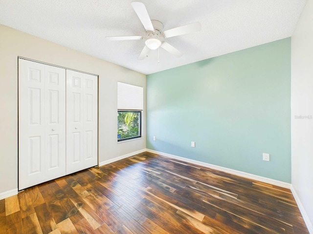 unfurnished bedroom featuring baseboards, ceiling fan, wood finished floors, a textured ceiling, and a closet