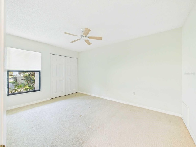 unfurnished bedroom featuring carpet floors, a closet, and baseboards