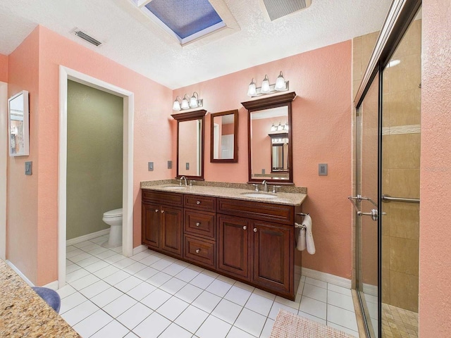 bathroom featuring a stall shower, visible vents, a sink, and toilet