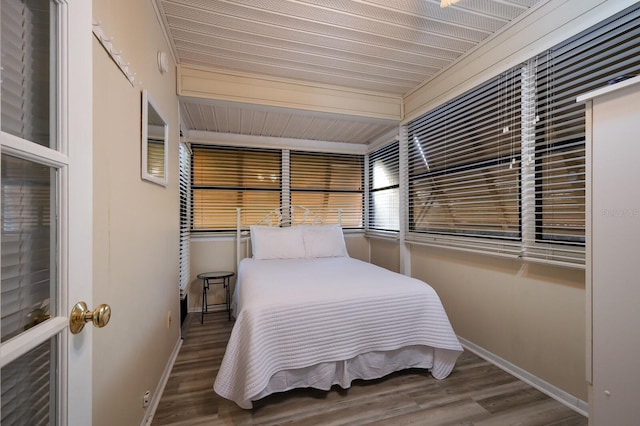 bedroom with baseboards and wood finished floors