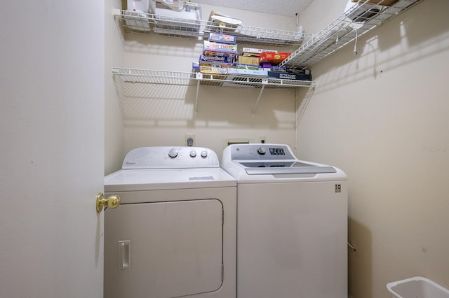 clothes washing area with laundry area and washing machine and clothes dryer