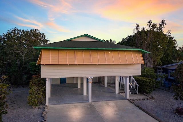 view of front of property with a carport and driveway