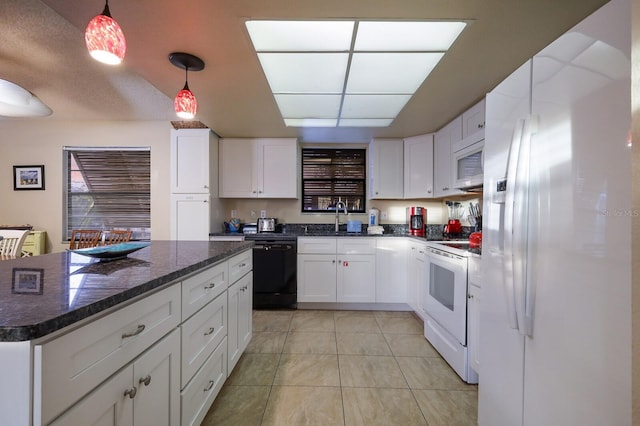 kitchen with white appliances, white cabinets, light tile patterned floors, and a sink