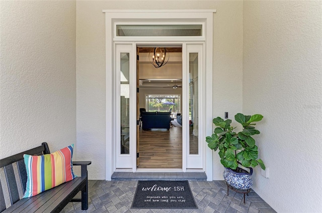 entrance to property featuring stucco siding