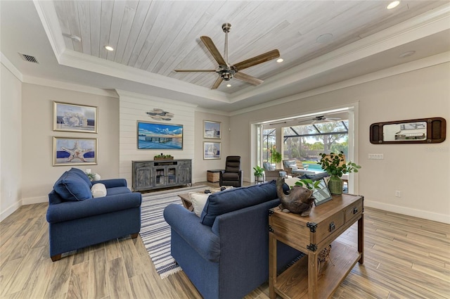 living room featuring visible vents, baseboards, wood ceiling, a tray ceiling, and light wood-type flooring