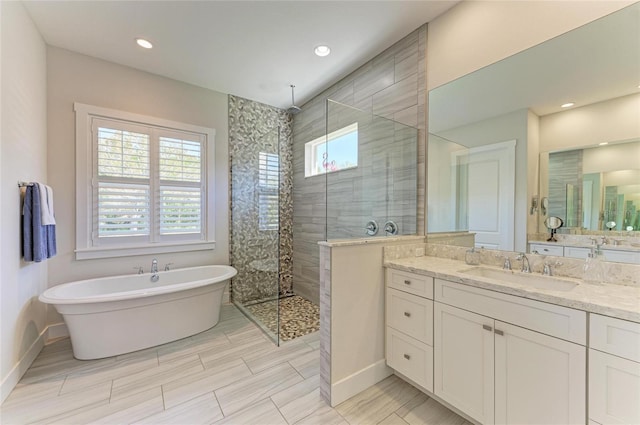 full bathroom featuring a walk in shower, recessed lighting, vanity, baseboards, and a freestanding bath