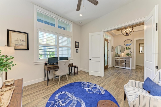 home office featuring recessed lighting, lofted ceiling, wood finished floors, baseboards, and ceiling fan with notable chandelier