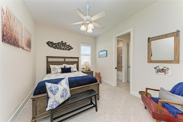 bedroom with a ceiling fan, baseboards, carpet flooring, and ensuite bathroom