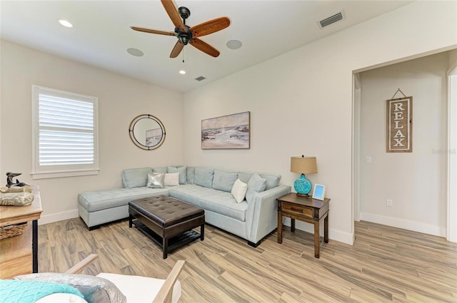 living room with light wood-style floors, recessed lighting, visible vents, and baseboards