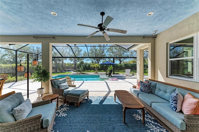 sunroom featuring a swimming pool and a ceiling fan