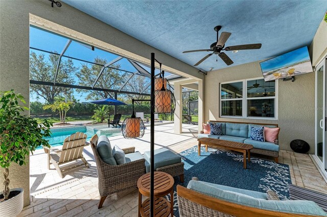 view of patio / terrace featuring an outdoor pool, a lanai, ceiling fan, and an outdoor hangout area