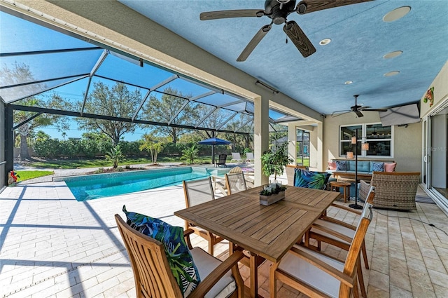 view of patio featuring an outdoor pool, a ceiling fan, glass enclosure, an outdoor hangout area, and outdoor dining space