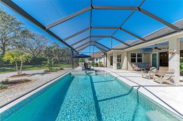 pool with a ceiling fan, glass enclosure, and a patio