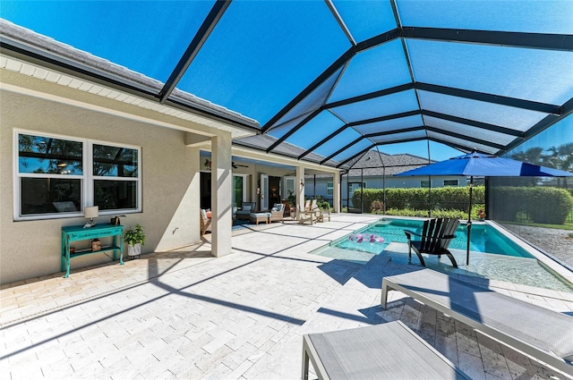 view of pool featuring ceiling fan, a patio, a lanai, and a fenced in pool