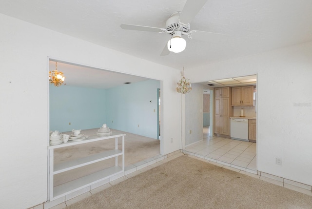 interior space featuring ceiling fan with notable chandelier, light tile patterned flooring, and light colored carpet