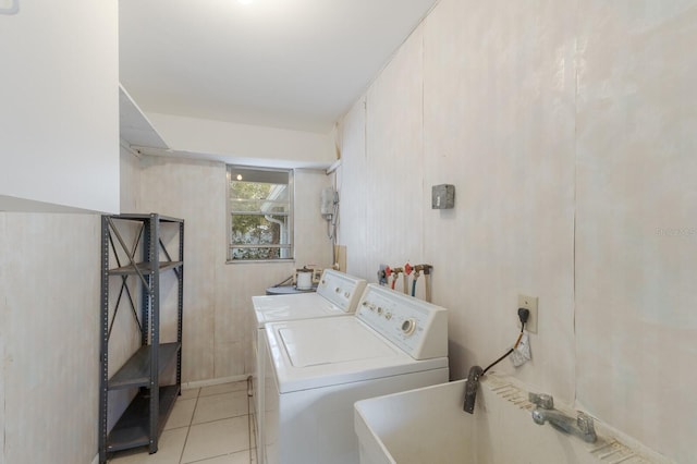 laundry area featuring laundry area, light tile patterned flooring, and washing machine and dryer