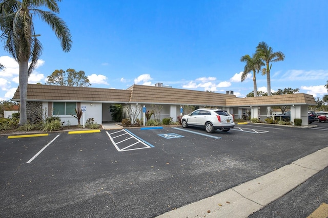 view of property featuring uncovered parking