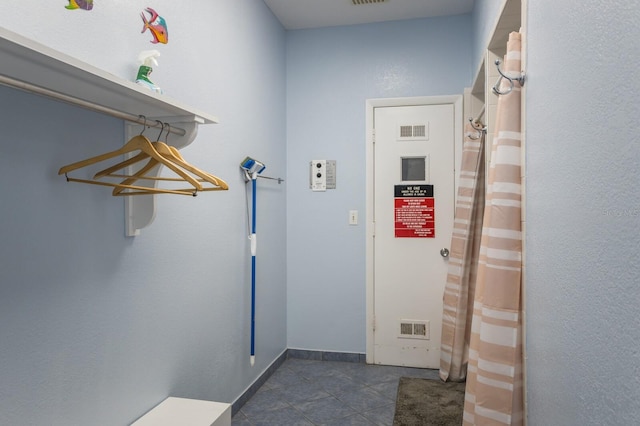 interior space with visible vents, baseboards, and tile patterned floors