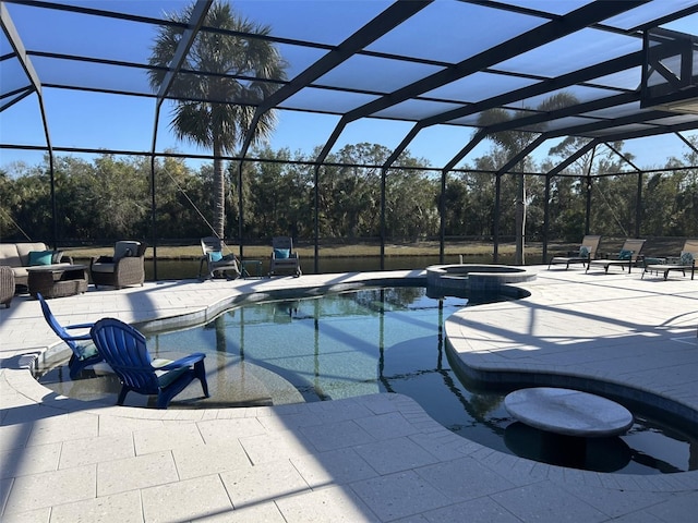 view of swimming pool with glass enclosure, a pool with connected hot tub, and a patio