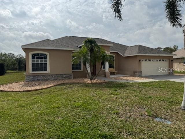 single story home with a front yard, concrete driveway, an attached garage, and stucco siding