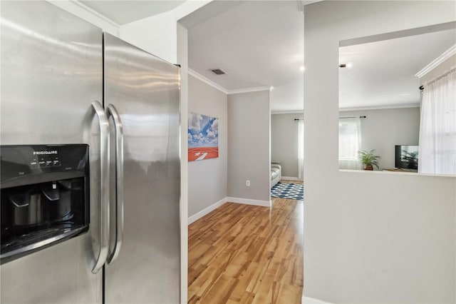 kitchen with wood finished floors, baseboards, visible vents, stainless steel fridge with ice dispenser, and ornamental molding