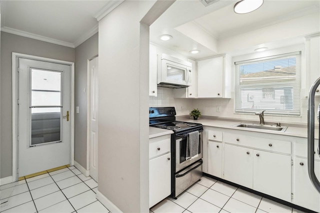 kitchen featuring white microwave, crown molding, light tile patterned floors, stainless steel range with electric cooktop, and a sink