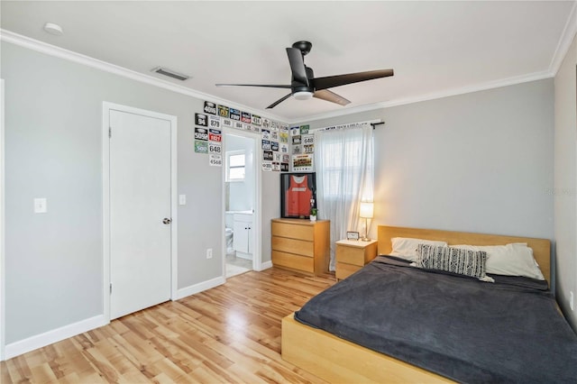 bedroom featuring wood finished floors, visible vents, baseboards, ensuite bathroom, and crown molding