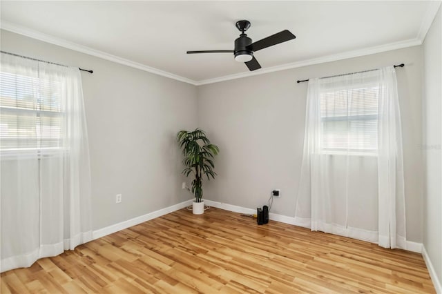 spare room with a ceiling fan, crown molding, baseboards, and light wood-type flooring