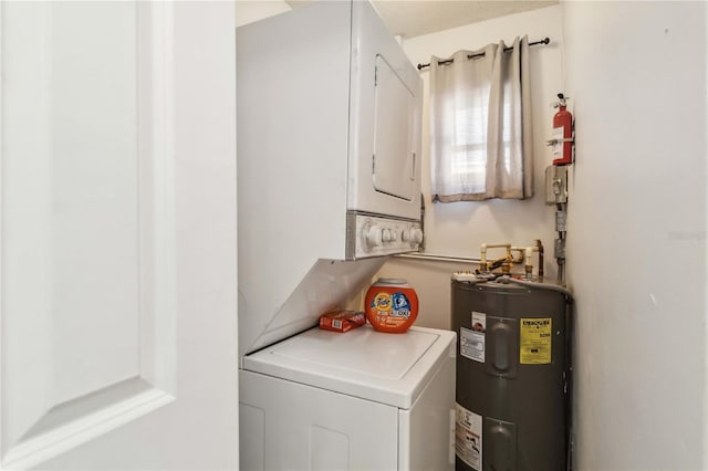 laundry area with water heater and stacked washer and dryer