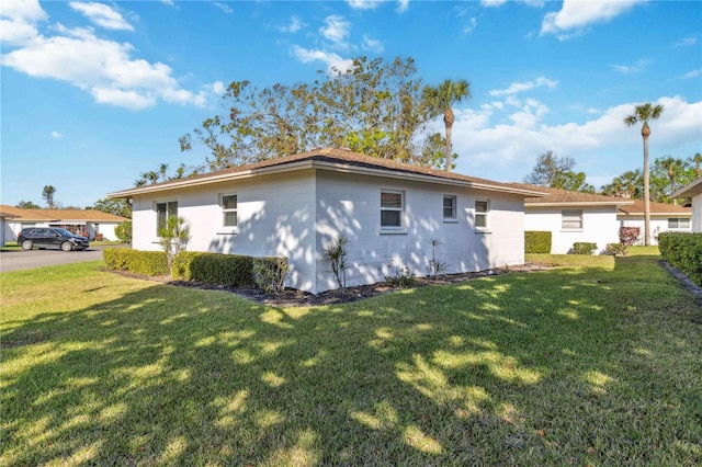 rear view of property featuring a yard