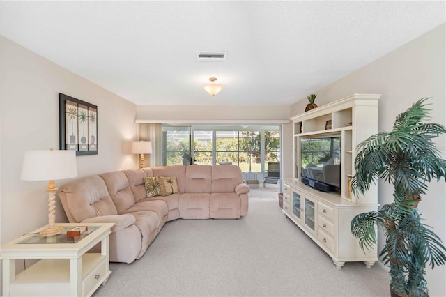 living room with visible vents and light colored carpet