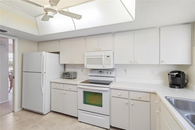 kitchen with a sink, white appliances, light countertops, and ceiling fan