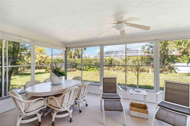 sunroom / solarium featuring a ceiling fan