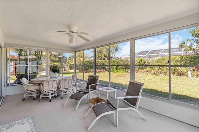 sunroom / solarium featuring a ceiling fan