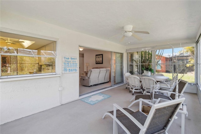 sunroom / solarium with a ceiling fan