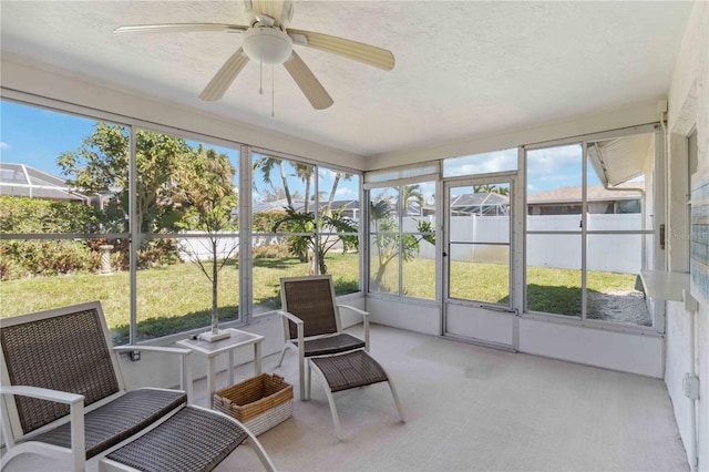 sunroom with a healthy amount of sunlight and a ceiling fan