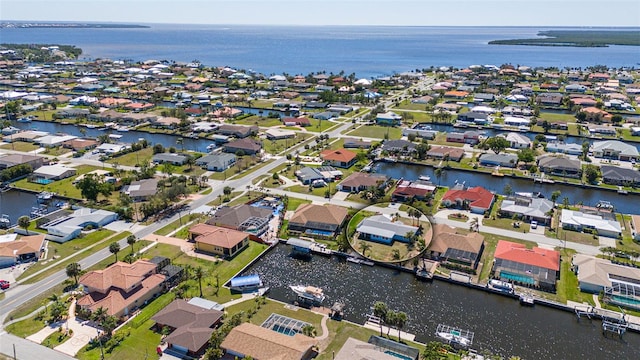 bird's eye view with a residential view and a water view