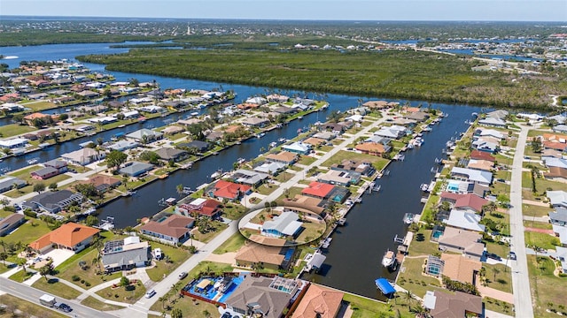 birds eye view of property with a residential view and a water view