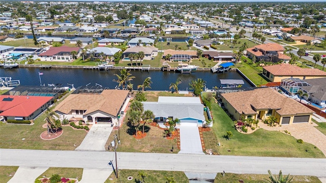 birds eye view of property with a residential view and a water view