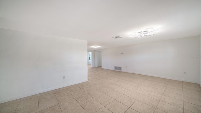 spare room with baseboards and visible vents