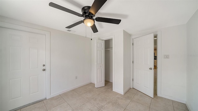 unfurnished bedroom featuring a ceiling fan, baseboards, visible vents, light tile patterned flooring, and a closet