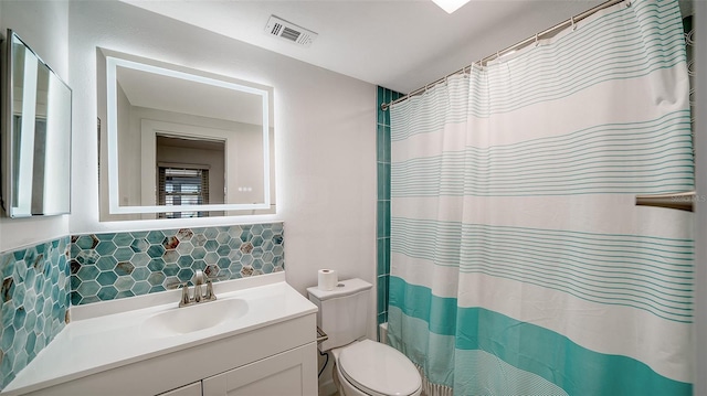 bathroom featuring visible vents, backsplash, toilet, a shower with curtain, and vanity