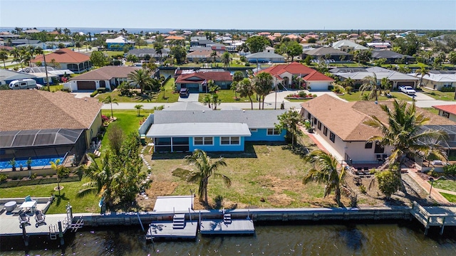 drone / aerial view with a residential view and a water view