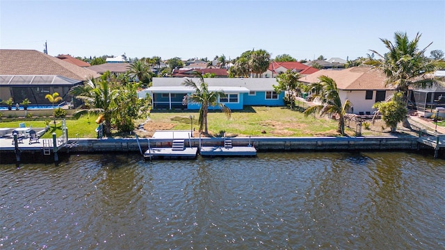 exterior space with a residential view, a yard, and a water view