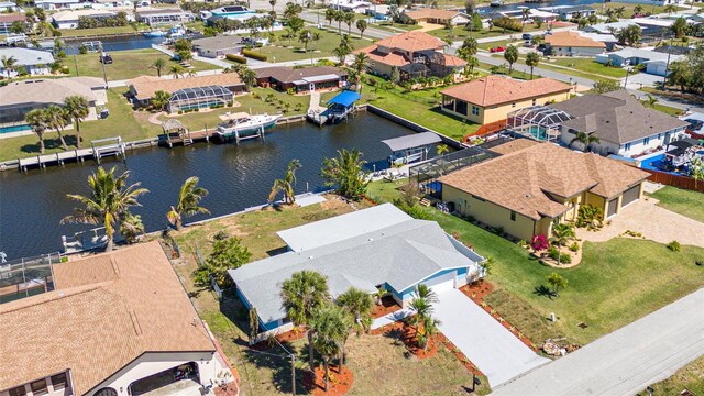 birds eye view of property with a residential view and a water view