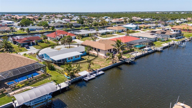 birds eye view of property featuring a residential view and a water view